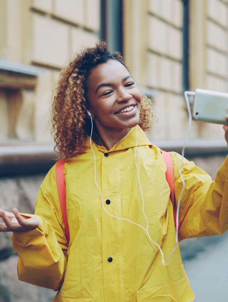Young woman filming herself on a city street